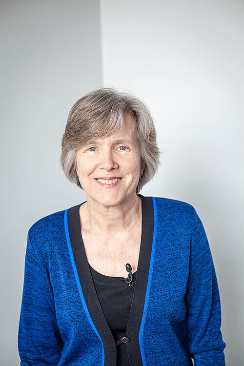 Portrait of Dr. Ann S. Masten, smiling, at PopTech 2012 in Camden, Maine